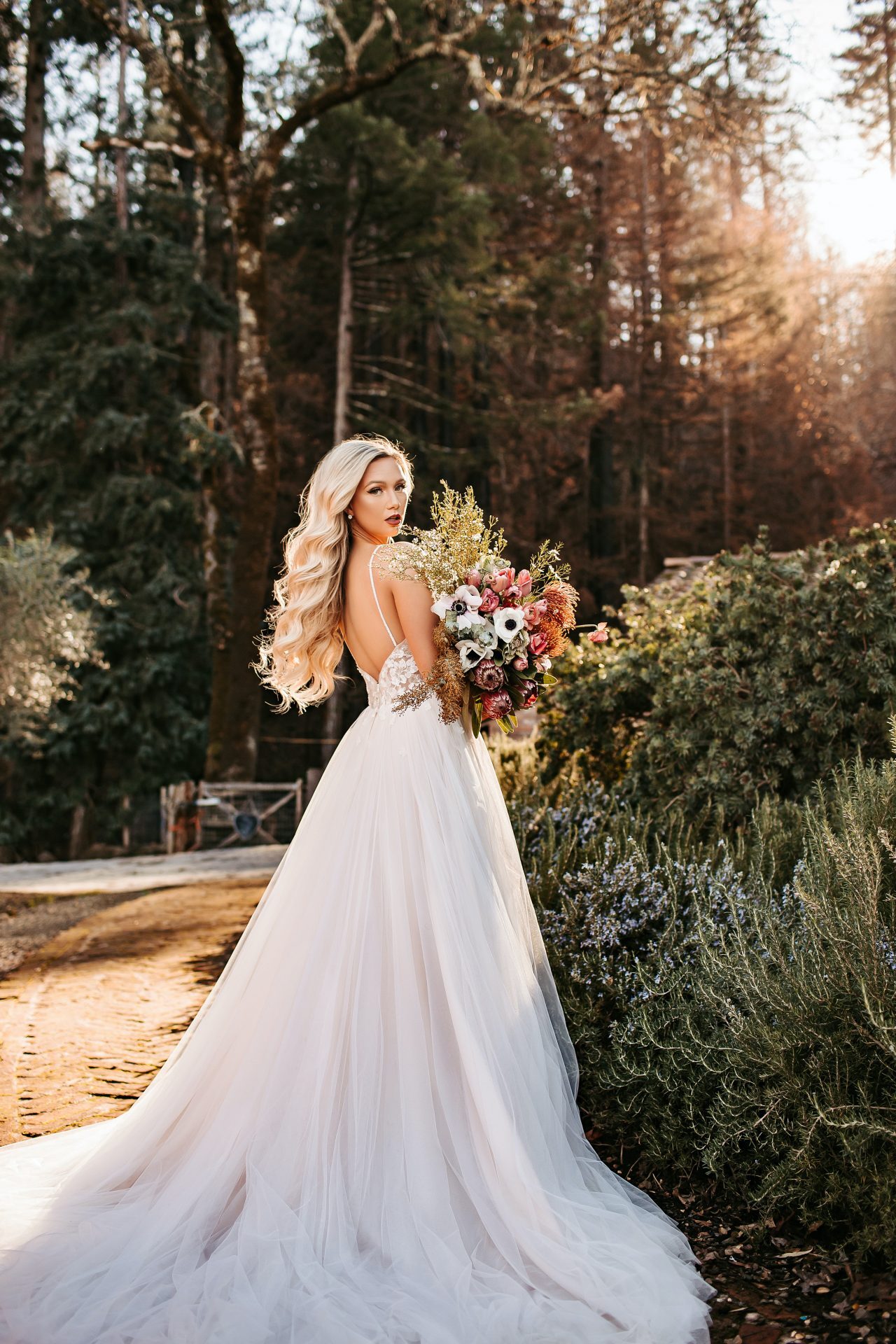Model wearing a white Stella York Gown