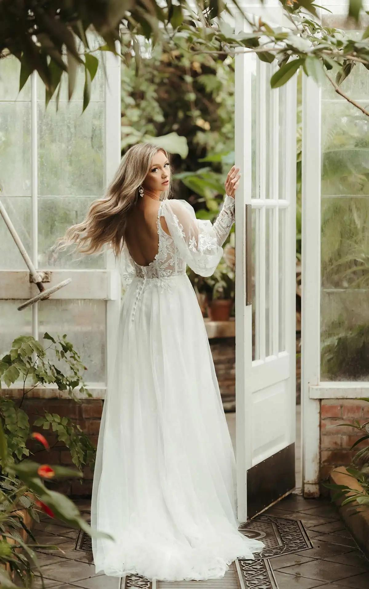 Model wearing a white Stella York Gown