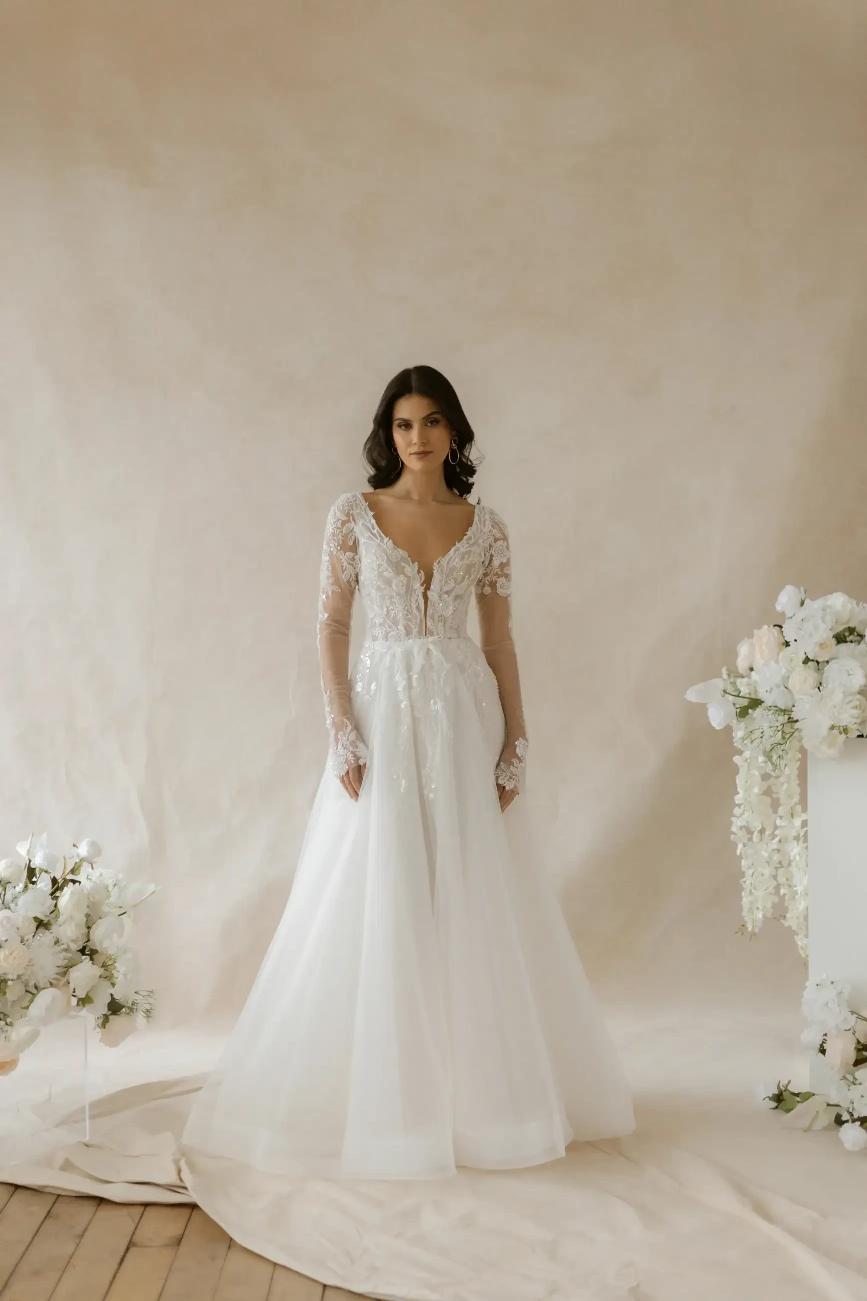 model is wearing an illusion long sleeve bridal gown