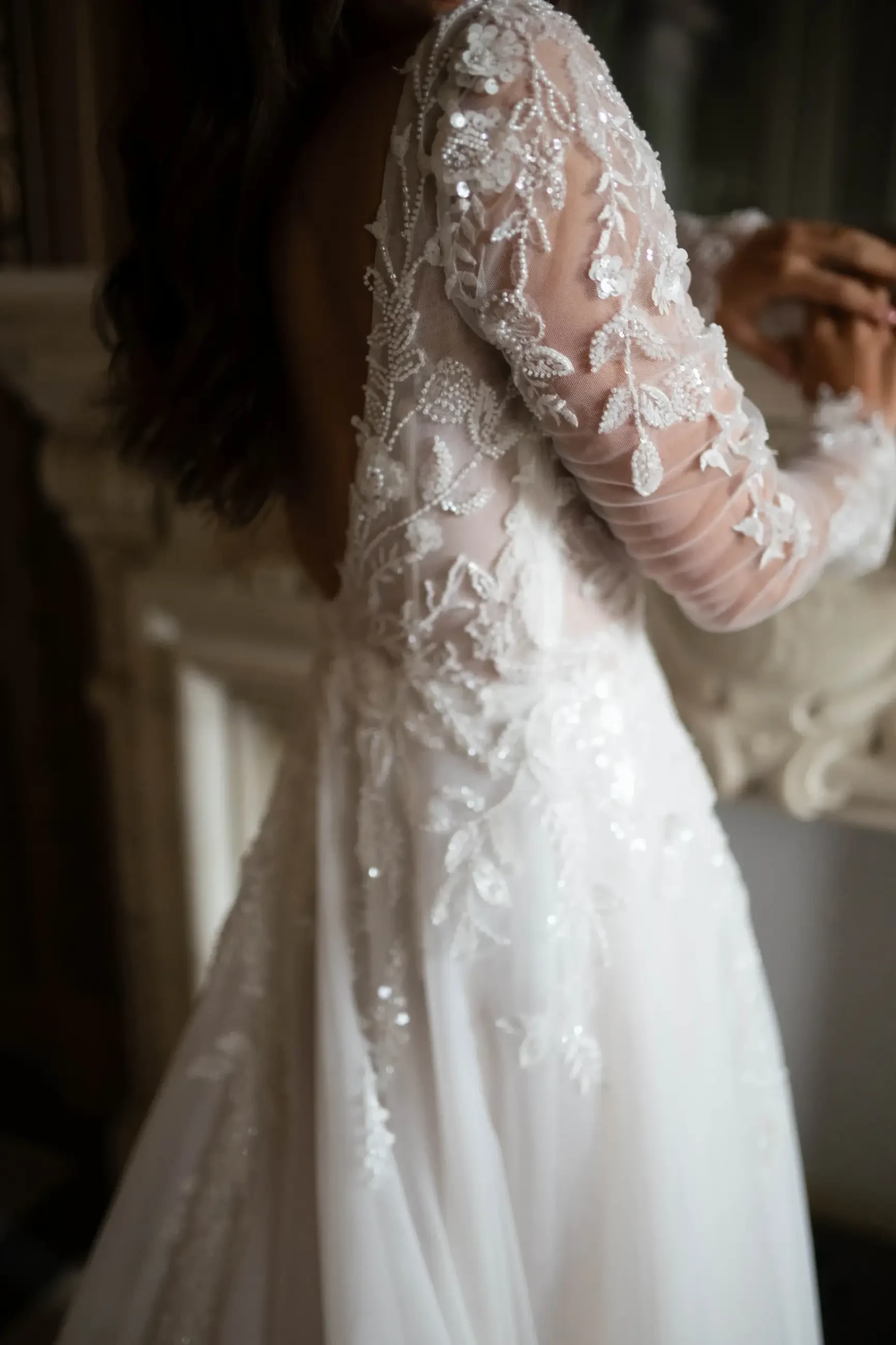 model is wearing an illusion long sleeve bridal gown