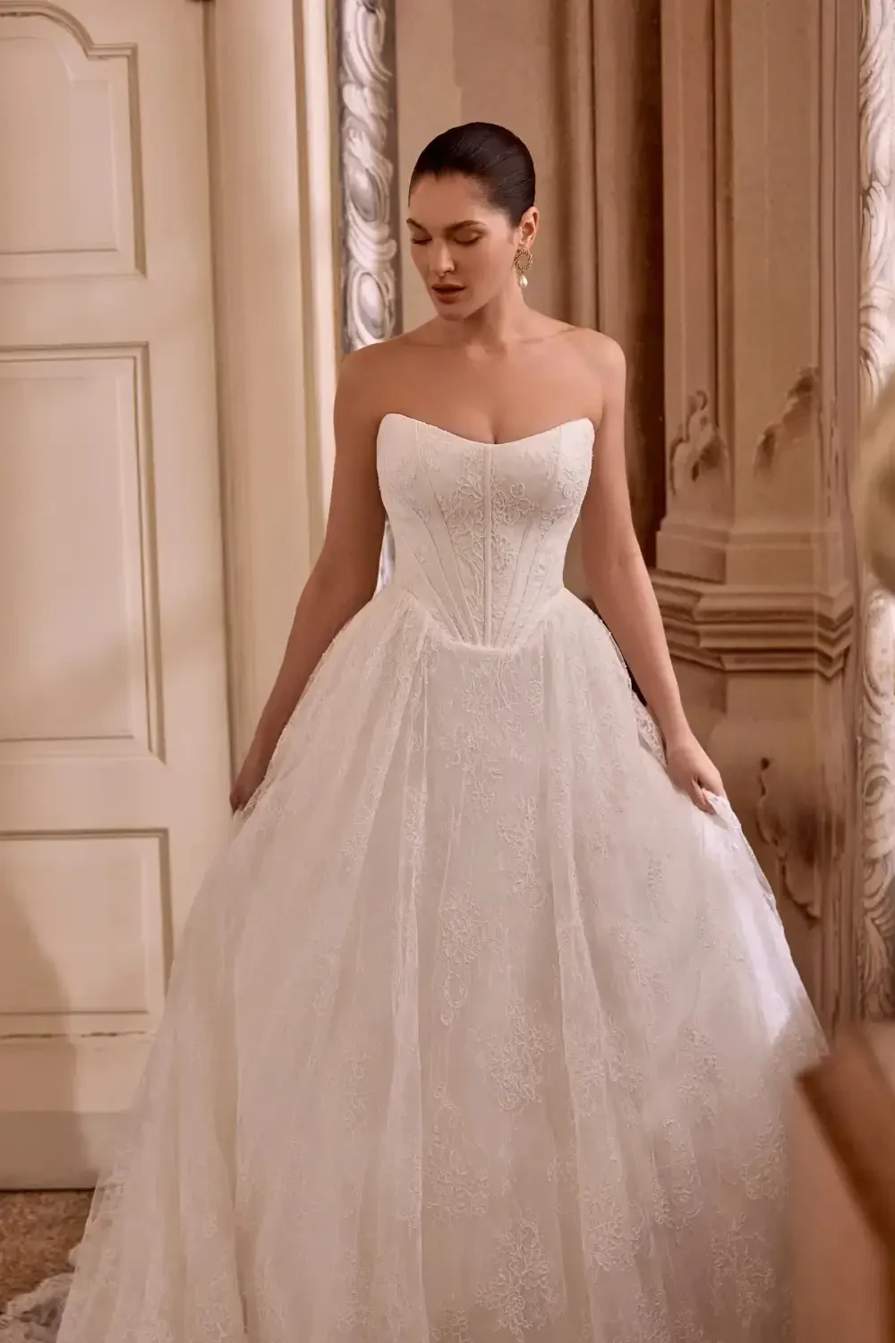 A model wearing a strapless white wedding gown.