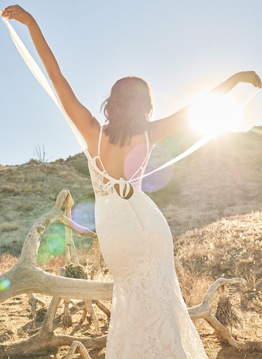 Model wearing a white Lillian West Gown