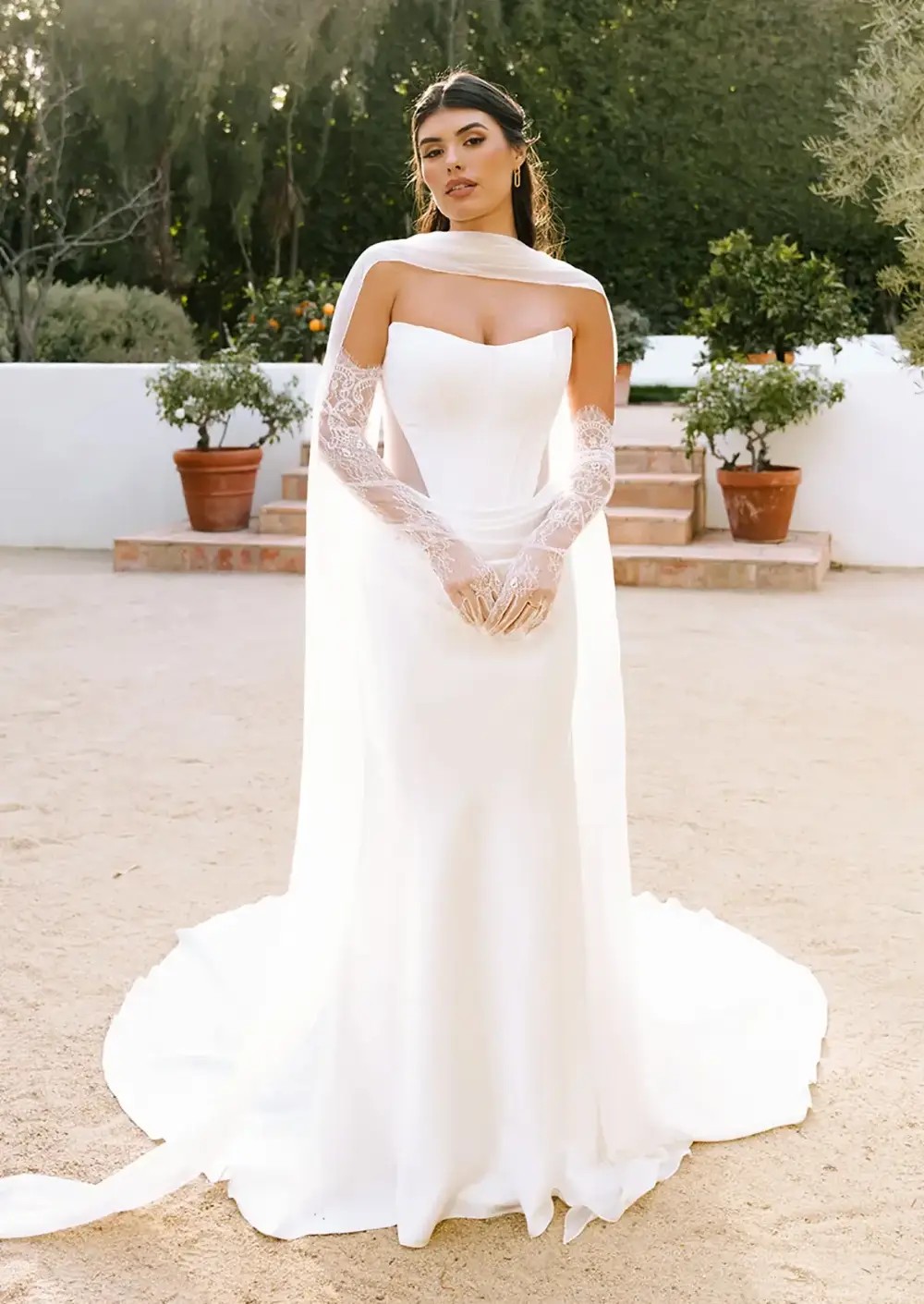Model wearing a white Stella York Gown